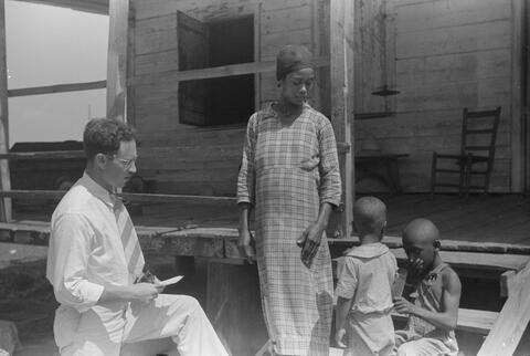 Public health doctor giving tenant family medicine for malaria near Colombia, South Carolina, 1939 (Photo: Marion Post Wolcott, Library of Congress).
